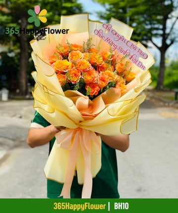 Bó hoa hồng cam phối cỏ lá xanh gói giấy vàng kem BH10